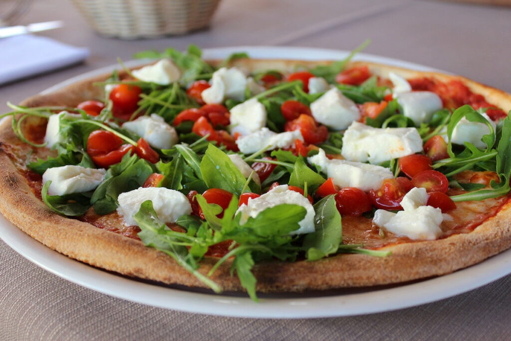 a vegetarian pizza on a plate, authentic Italian food