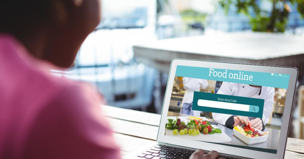 A woman opening a restaurant website with affiliate