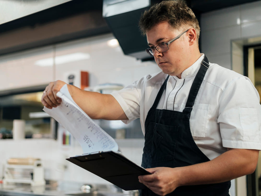 A manager checking a restaurant operations manual