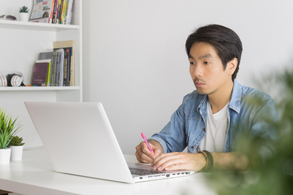 A man doing test online with laptop from home