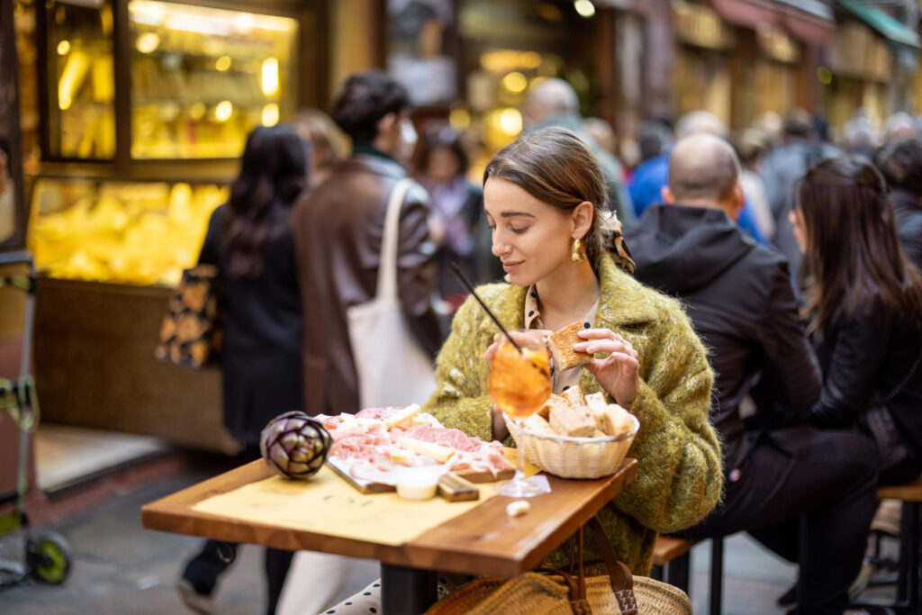 A woman with snacks and drink at outdoor dining