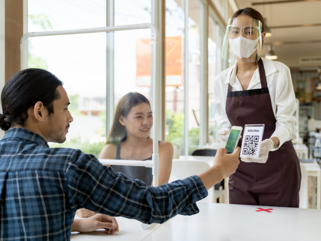 A man customer scan online menu from waitress