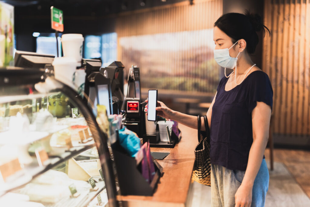 A woman paying self-service cashless payment with scan a cell phone