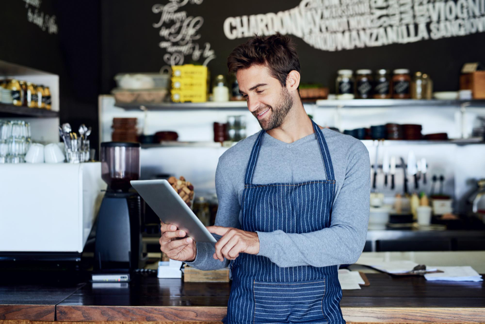 A restaurant manager holding a tablet