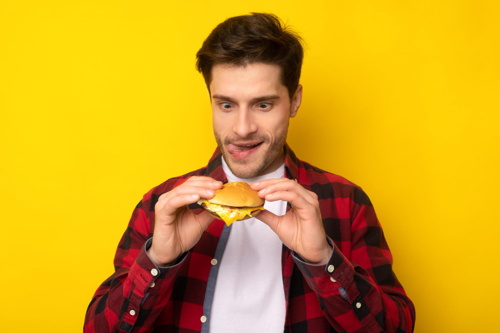 A fun man holding a burger