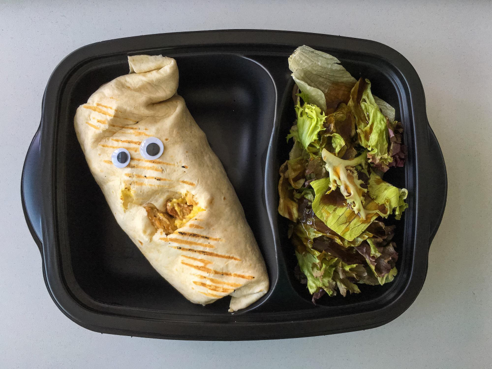 Close-up of burrito with googly eyes
